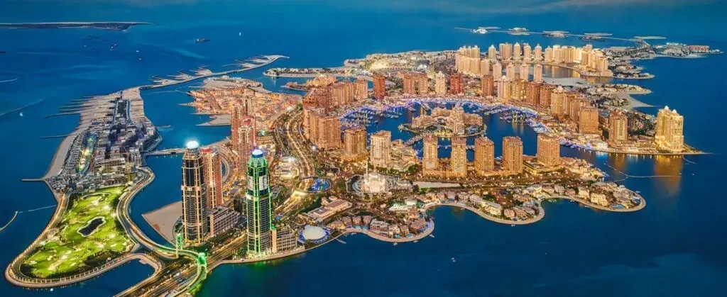 Night aerial view of residential towers and the marina at The Pearl-Qatar in Doha
